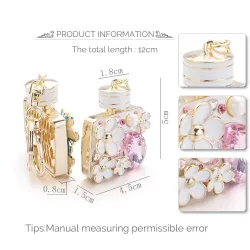 Bouteille de parfum avec des cristaux et des fleurs - porte-clés