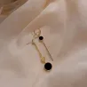 AretesPendientes largos con círculo negro
