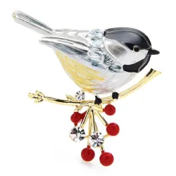 A bird sitting on a branch - crystal brooch