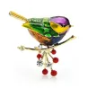 A bird sitting on a branch - crystal brooch