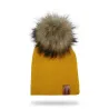 Stickad mössa med pom pom / läder etikett - unisex - för barn / vuxna