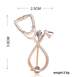 Broche in de vorm van een stethoscoop met kristalBroches
