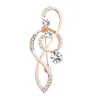 Broche en or luxueuse - avec note de musique en cristal