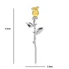 Elegant silver brooch with a golden rose