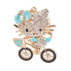 Chaton en cristal sur un vélo - porte-clés
