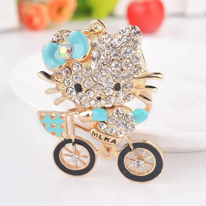 Chaton en cristal sur un vélo - porte-clés