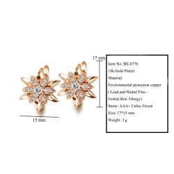 Gyldne blomsterøreringe med krystaller