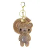 Ursinho de cristal com pompom de pelo - chaveiro