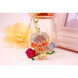 Crâne en cristal doré avec rose - porte-clés