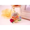 Crâne en cristal doré avec rose - porte-clés