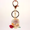 Crâne en cristal doré avec rose - porte-clés