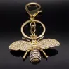 Porte-clés doré avec une abeille en cristal