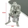 Skeleton sitting on the toilet - rubber keychainKeyrings