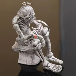 Skeleton sitting on the toilet - rubber keychainKeyrings