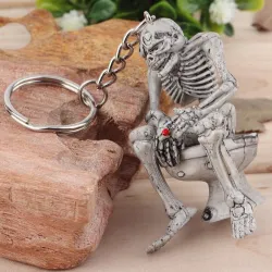 Skeleton istuu wc - kumi avaimenperä
