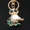 Sitting on the branch white crystal owl - keychainKeyrings