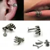 Body piercing with skull handEarrings