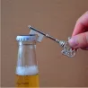 Key shaped bottle opener with keyring